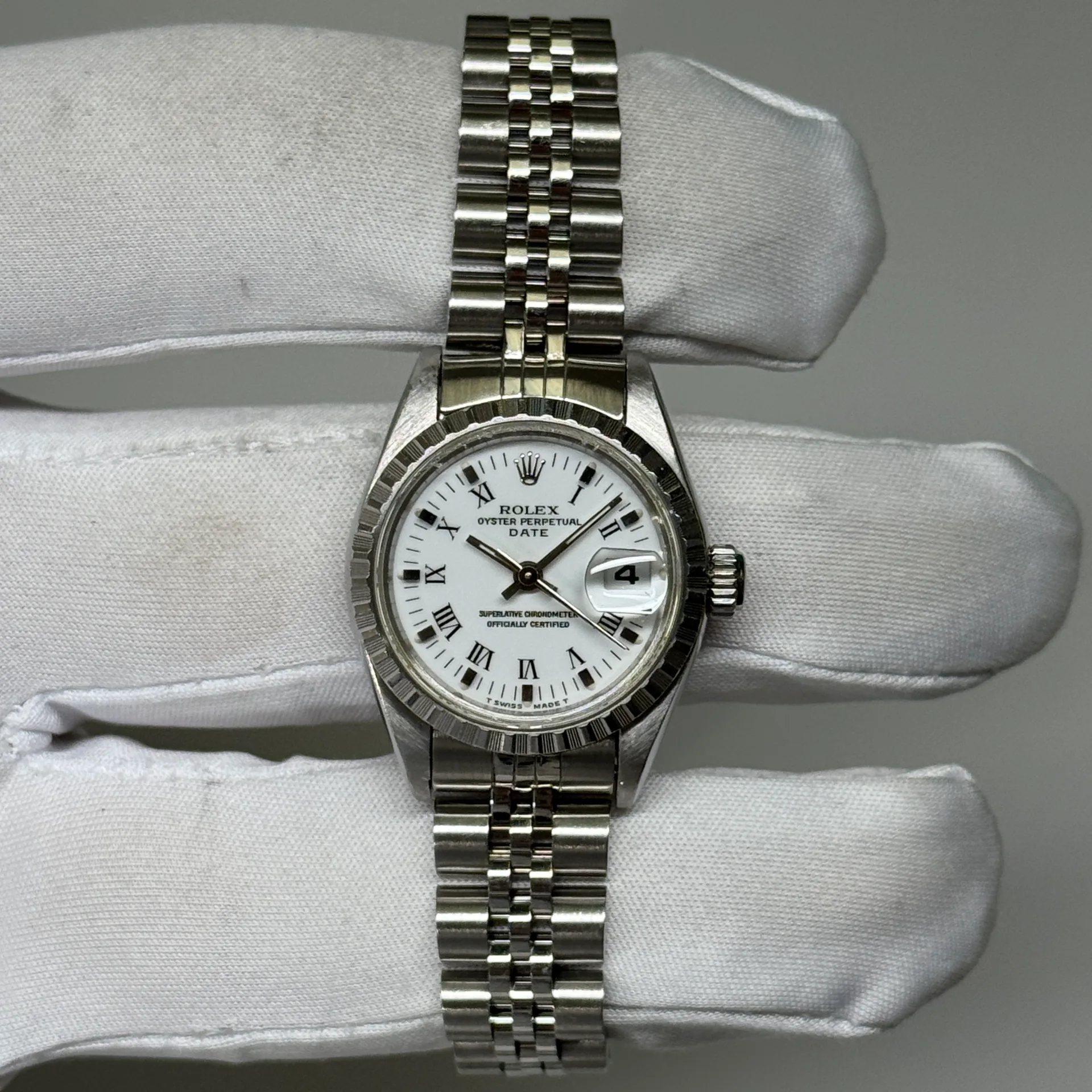 1994 Rolex  Oyster Perpetual Date 26 Steel / Engine-Turned / White / Roman / Jubilee 69240